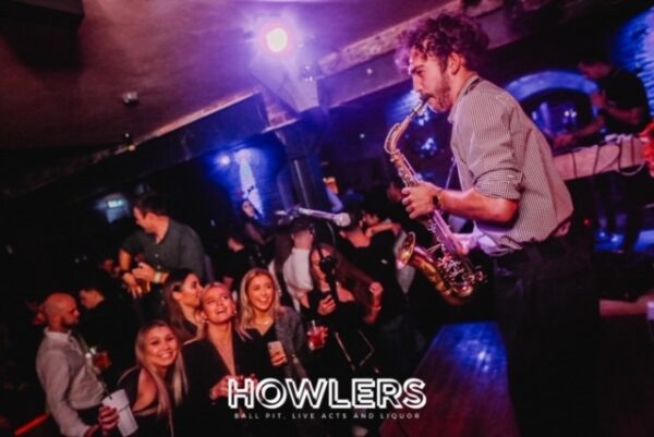 a group of girls cheering the Saxophonist on the stage in howlers newcastle.